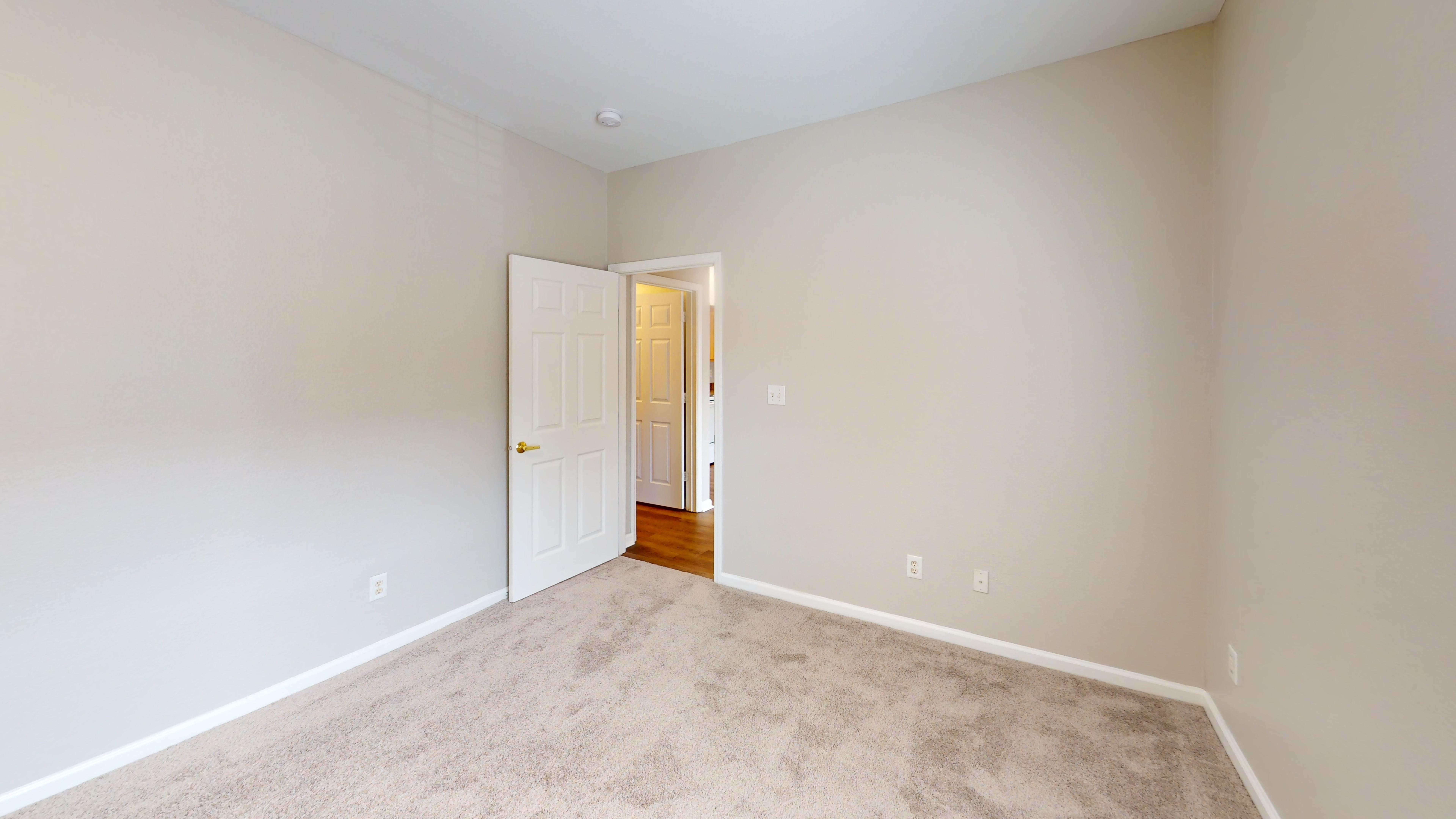 Comfortable bedroom with carpet and ample natural light