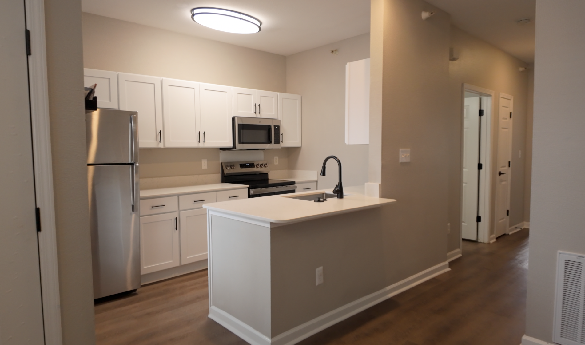 Modern kitchen with white cabinets and stainless steel appliances